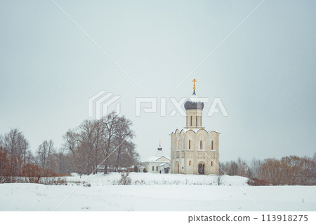 a church in winter in the middle of a snow-covered field a church in winter in the middle of a snow-covered field 113918275