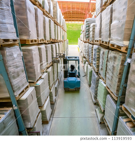 Forklift Moving Through Warehouse Filled With Boxes. Generative AI 113919593