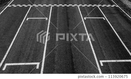 Aerial view abstract asphalt black Start and Finish grid line for race car in circuit texture background, Automobile and automotive background. Aerial view abstract asphalt black Start and Finish grid line for race car in circuit texture background, Automobile and automotive background. 113920675