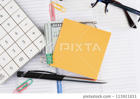A businessman's workplace with a yellow sticker attached to dollar bills. A place to copy A businessman's workplace with a yellow sticker attached to dollar bills. A place to copy 113921831