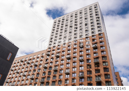 Residential complex in Moscow. New buildings in Moscow, high-rise bright creative house and against the sky. There are many apartments with Windows. Residential complex in Moscow. New buildings in Moscow, high-rise bright creative house and against the sky. There are many apartments with Windows. 113922145