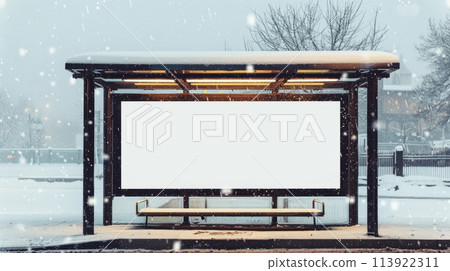 Blank billboard on bus stop during snowfall. Mockup for advertising banners or design. 113922311