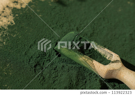 Organic blue-green algae spirulina powder food in wooden spoon. Copy space for your text Health benefits of spirulina chlorella. Vitamins and minerals to diet. Detox dietary supplement Seaweed Organic blue-green algae spirulina powder food in wooden spoon. Copy space for your text Health benefits of spirulina chlorella. Vitamins and minerals to diet. Detox dietary supplement Seaweed 113922323