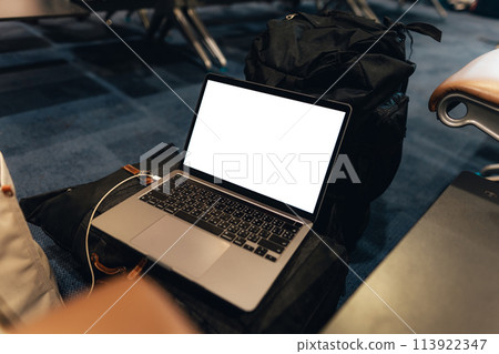 A laptop with blank screen on chair at airport A laptop with blank screen on chair at airport 113922347