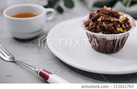 One black chocolate muffins with nuts crumbs One black chocolate muffins with nuts crumbs 113922763