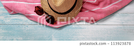 Summer Straw Hat, Towel and Sunglasses on Wooden Surface. File with Clipping Path. Summer Straw Hat, Towel and Sunglasses on Wooden Surface. File with Clipping Path. 113923878