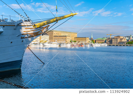 The historic Af Chapman, a full-rigged ship, is moored in Stockholm harbor with city buildings, Royal Palace and clear skies in the background. Stockholm, Sweden The historic Af Chapman, a full-rigged ship, is moored in Stockholm harbor with city buildings, Royal Palace and clear skies in the background. Stockholm, Sweden 113924902