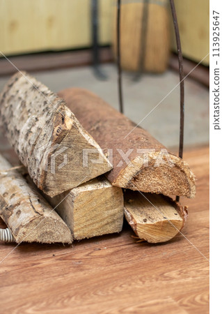 A stack of Brown logs on Hardwood floor, Wood stain on Planks A stack of Brown logs on Hardwood floor, Wood stain on Planks 113925647