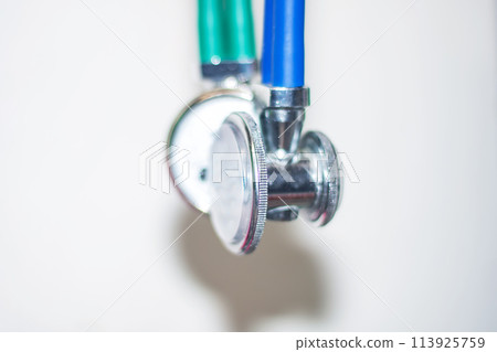 Close up of stethoscope with green and blue handles 113925759