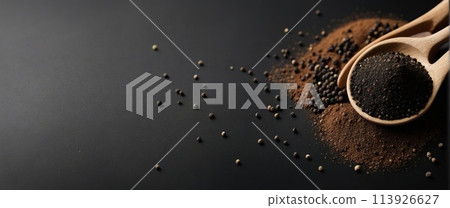 Black pepper powder on a black background. 113926627