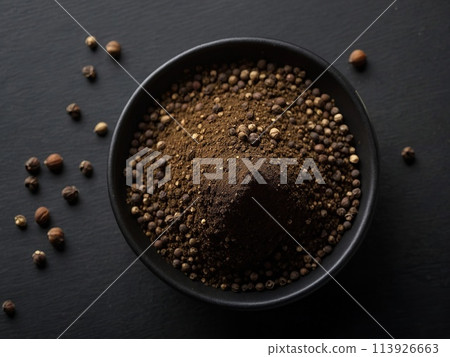 Black pepper powder on a black background. 113926663
