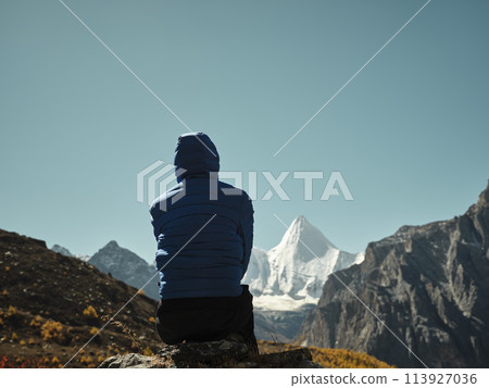 rear view of asian woman looking at Mount Yangmaiyong (or Jampayang in Tibetan) in Yading, China rear view of asian woman looking at Mount Yangmaiyong (or Jampayang in Tibetan) in Yading, China 113927036