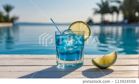summer blue cocktail with lime on wooden table near the swimming pool 113928508