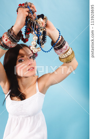 summer girl with plenty of jewellery, beads in hands summer girl with plenty of jewellery, beads in hands 113928695