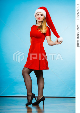 Woman wearing Santa Claus helper costume dress 113928995