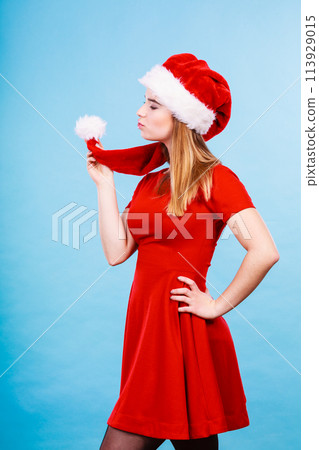 Happy woman wearing Santa Claus helper costume 113929015