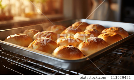 Baking sheet with warm rolls, retrieved by a homemaker, creates a cozy scene with inviting aroma. Baking sheet with warm rolls, retrieved by a homemaker, creates a cozy scene with inviting aroma. 113929431