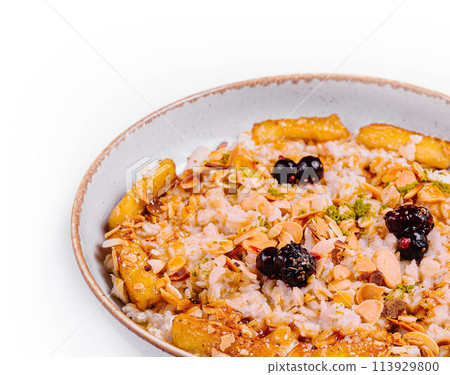Muesli with dried fruits and milk in ceramic bowl 113929800