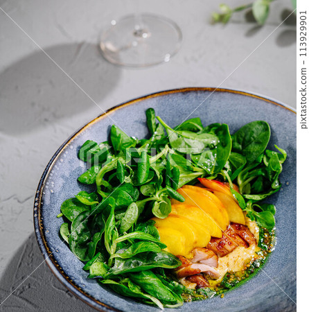 Appetizing pork meat baked with mango and cheese Appetizing pork meat baked with mango and cheese 113929901