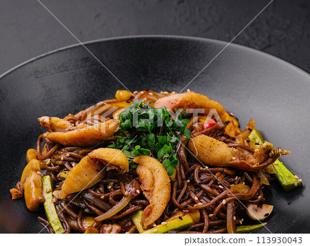 Chinese fried buckwheat pasta with meat on black plate Chinese fried buckwheat pasta with meat on black plate 113930043
