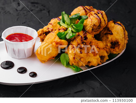 Traditional battered fried fish on plate Traditional battered fried fish on plate 113930100