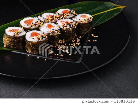 Sushi Rolls Set with Salmon on black plate 113930139