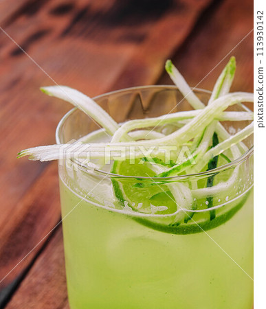 Glass of fresh mojito on wooden table 113930142