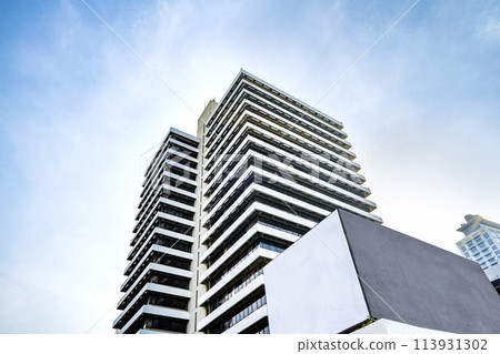 Low angle view of Jakarta city building corner against clear blu sky. 113931302