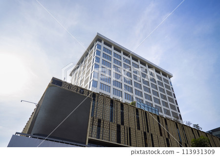 Low angle view of Jakarta city building corner against clear blu sky. 113931309