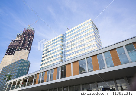 Low angle view of Jakarta city building corner against clear blu sky. 113931312