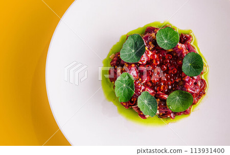 Tuna tartar with red caviar on big plate 113931400
