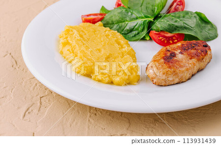 polenta with cutlet and cherry tomatoes with basil polenta with cutlet and cherry tomatoes with basil 113931439