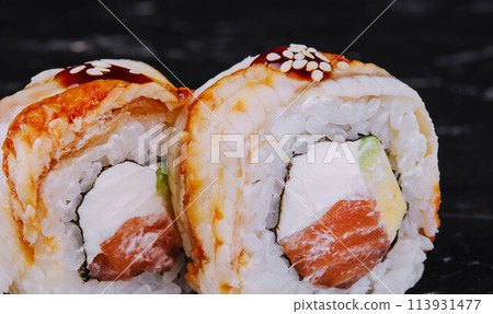 canada roll with salmon on black stone 113931477