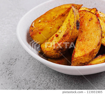 Roasted potato wedges with spices 113931905