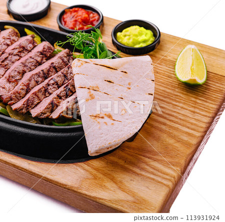 sliced fried meat with grilled vegetables and pita bread sliced fried meat with grilled vegetables and pita bread 113931924