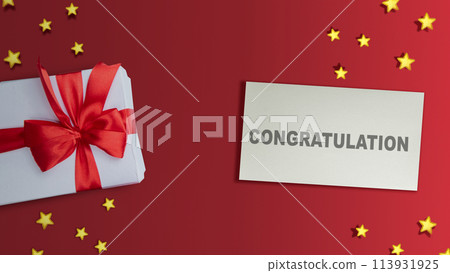 Gift box and paper with Congratulations text Gift box and paper with Congratulations text 113931925