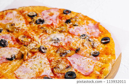 pizza with ham and mushrooms on a light background pizza with ham and mushrooms on a light background 113932011