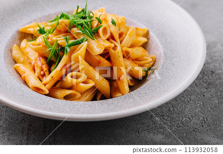 Penne pasta with tomato sauce 113932058