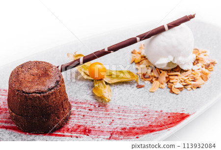 White plate with chocolate fondant cake White plate with chocolate fondant cake 113932084