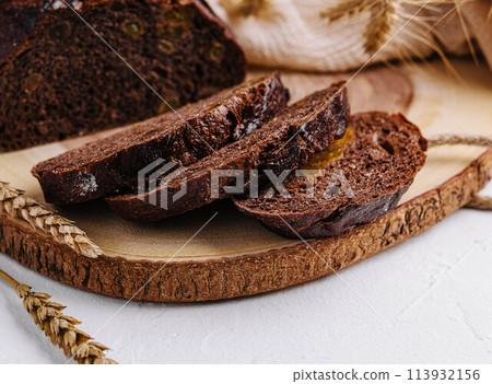 Black round bread on a cutting board 113932156