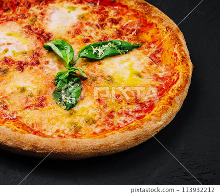 Margherita Pizza with Basil on Black Stone 113932212
