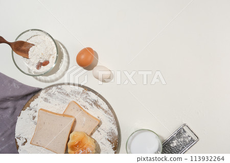 Top view of fresh dough recipe ingredients for delicious homemade cakes on white kitchen table. Flat lay and space for recipe, culinary classes, cooking blog 113932264