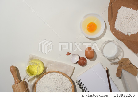 Copy space photo with essential baking ingredients flat lay on white kitchen counter top, available photo whether you advertising bread, brownies, cookies, cakes or tarts. Platform showcase for bakery Copy space photo with essential baking ingredients flat lay on white kitchen counter top, available photo whether you advertising bread, brownies, cookies, cakes or tarts. Platform showcase for bakery 113932269