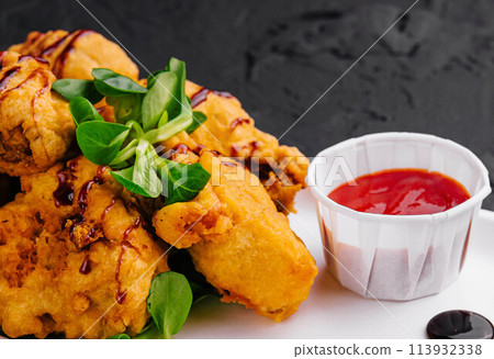 Traditional battered fried fish on plate Traditional battered fried fish on plate 113932338