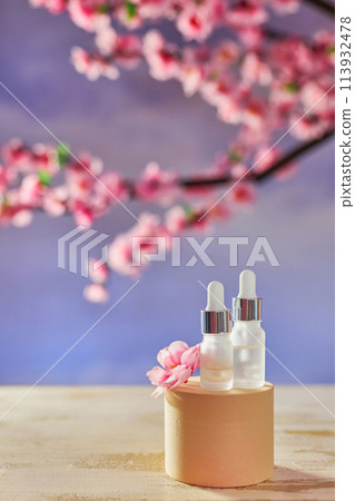 Glass bottle with pipette and serum on a podium Glass bottle with pipette and serum on a podium 113932478