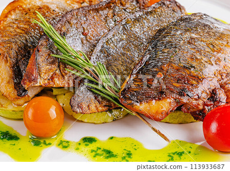 fried fish with vegetables on plate fried fish with vegetables on plate 113933687