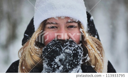 A young girl freezes in the woods in winter. A young girl freezes in the woods in winter. 113933795