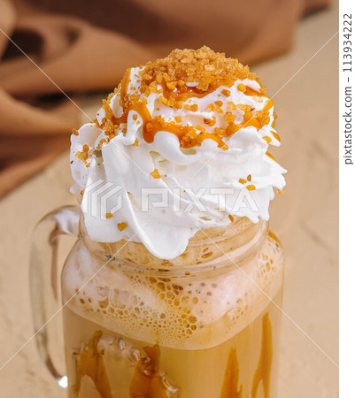 Caramel iced latte with whipped cream and syrup 113934222