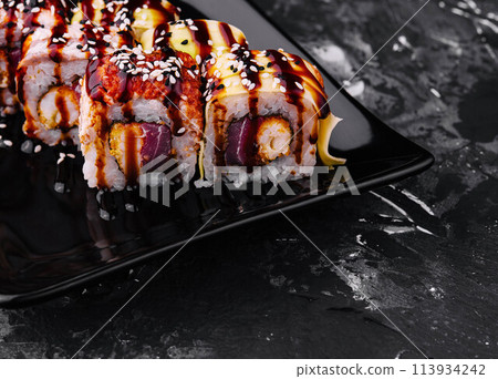 Canada roll with eel on black plate Canada roll with eel on black plate 113934242