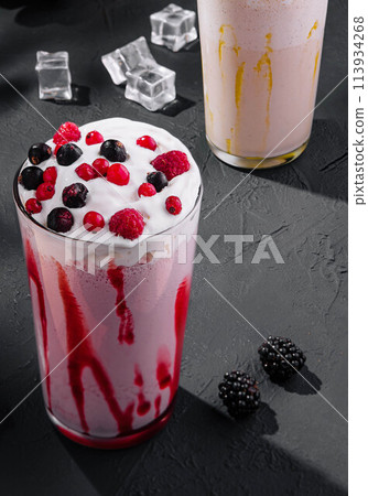 Delicious milkshakes on black stone with ice cubes 113934268